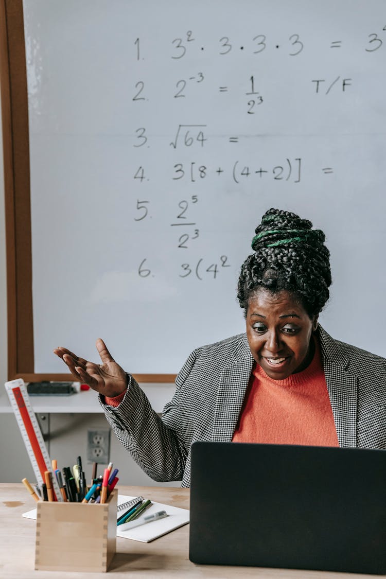 Excited Black Teacher Explaining Lesson Online With Laptop