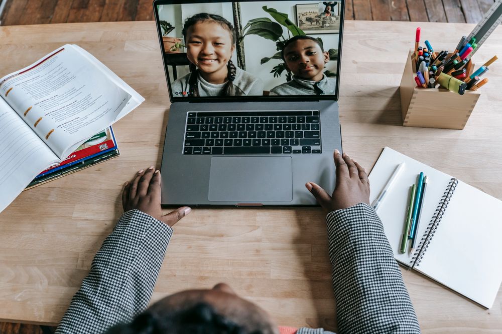 A teacher leading an online lesson on a laptop