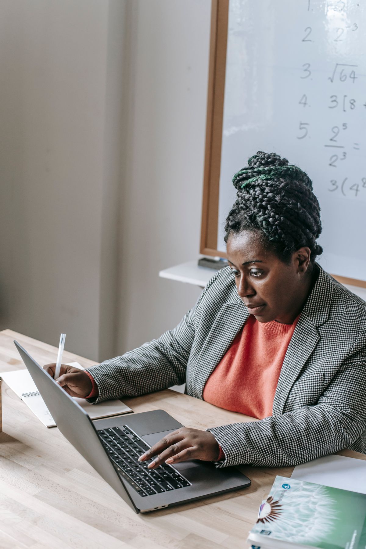Black consultant reviewing financial plans on laptop