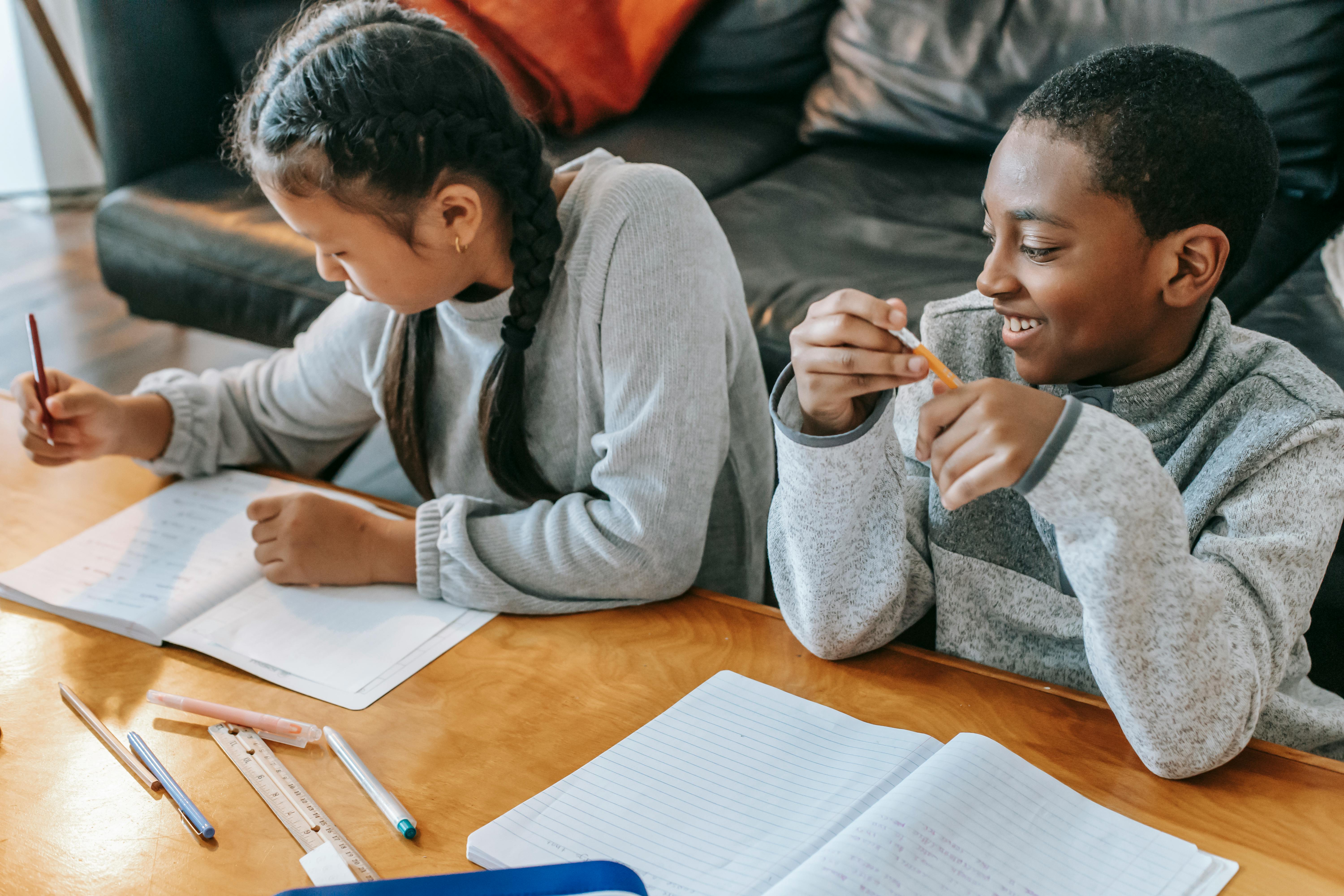 diverse kids studying together at home