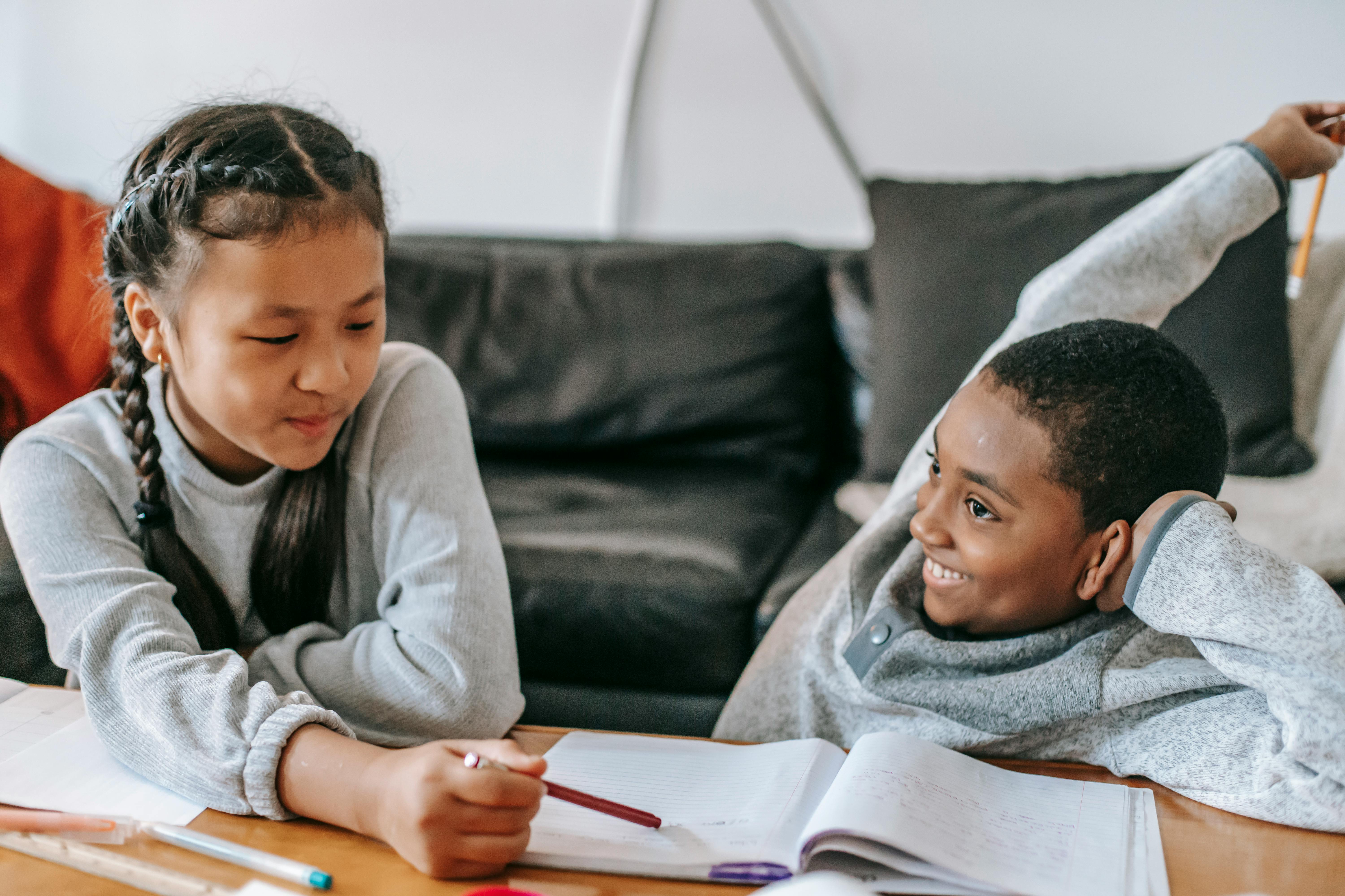 multiracial children doing homework at home