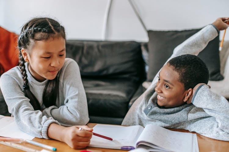 Multiracial Children Doing Homework At Home