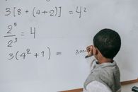Concentrated black kid doing sums