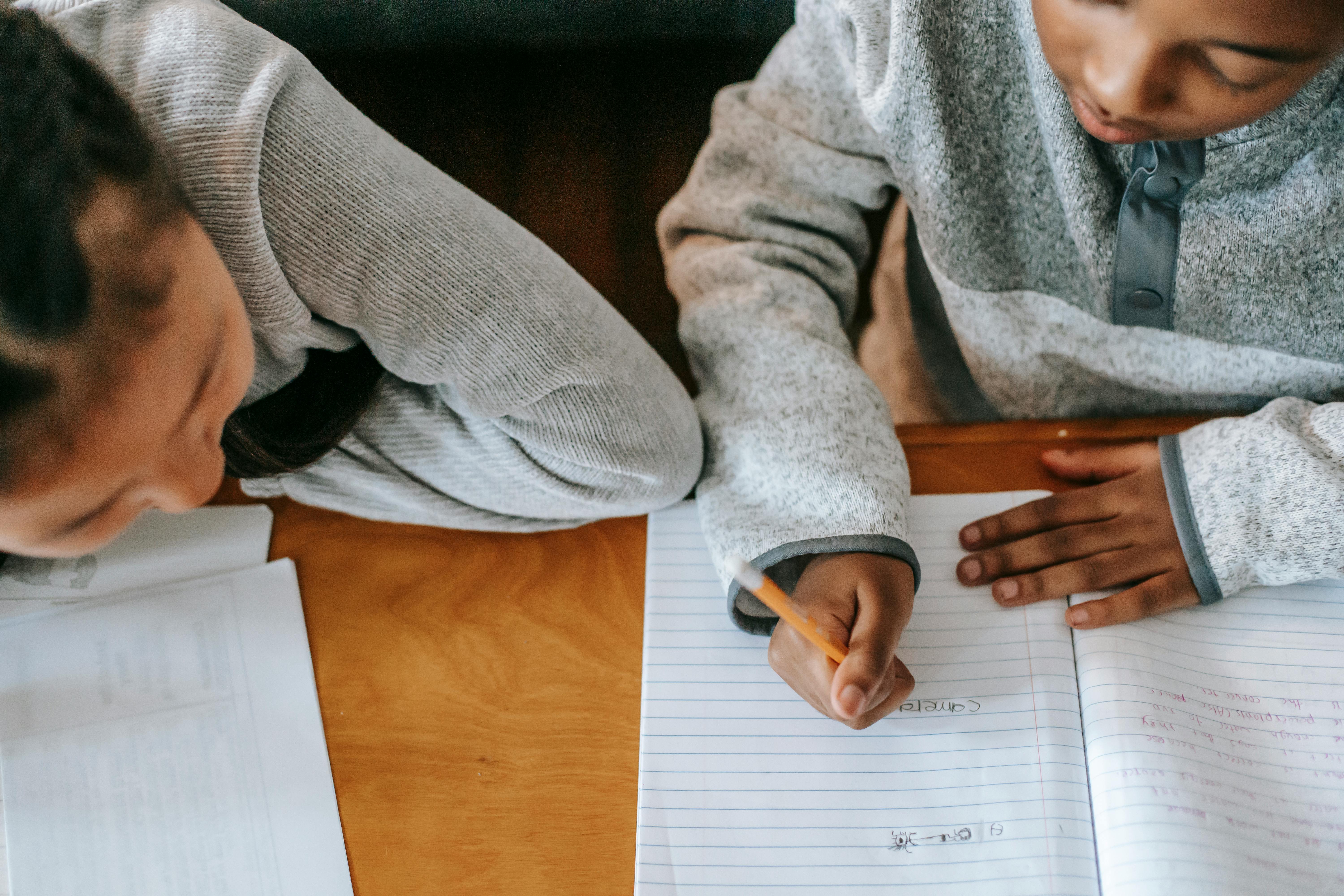 crop diverse classmates doing homework