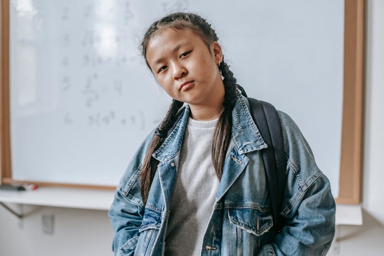 Serious Ethnic Schoolgirl In Classroom