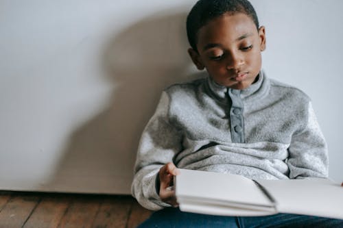 Free Thoughtful black boy with copybook Stock Photo