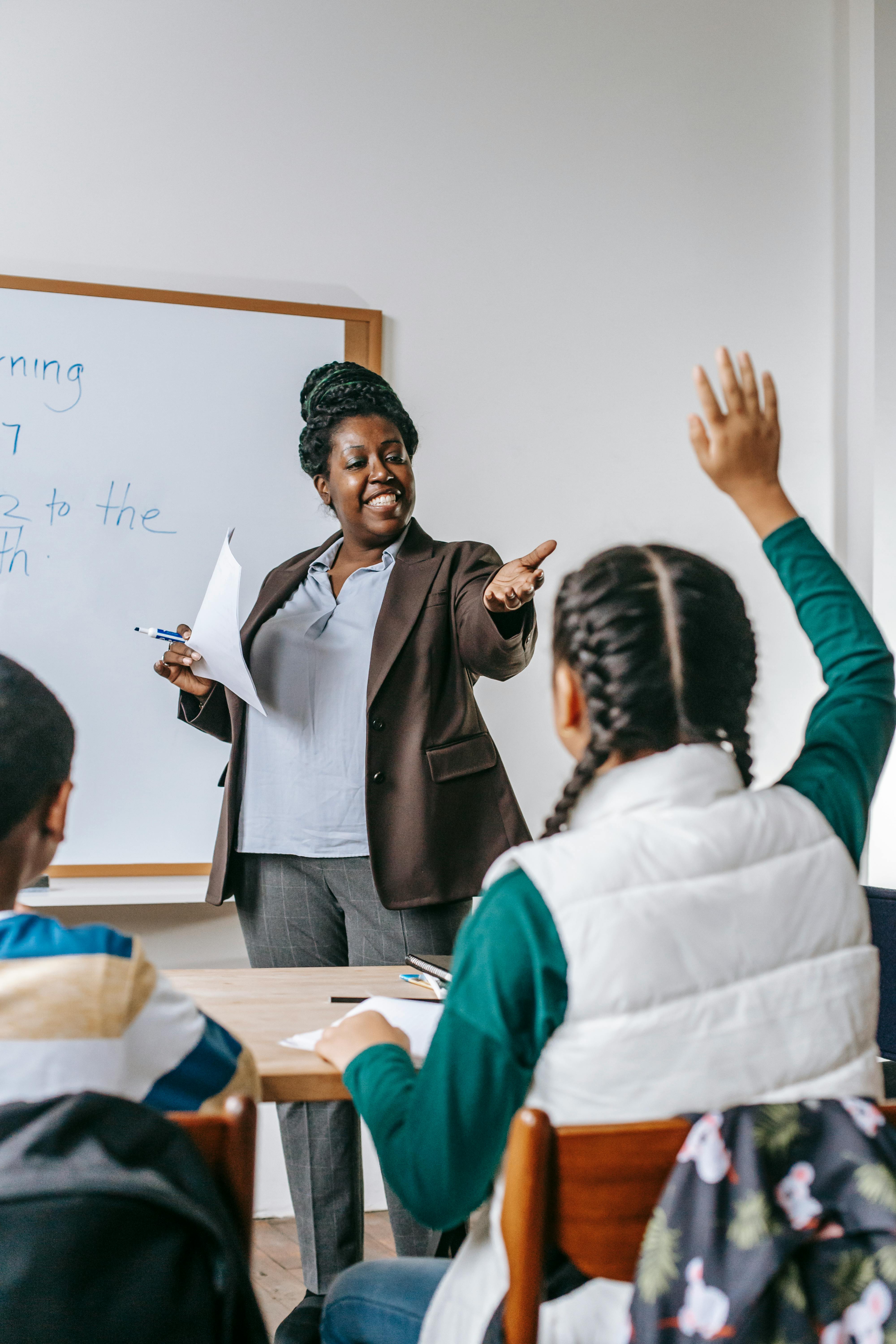 black teacher answering questions of pupil