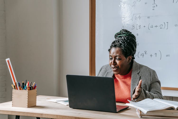 Black Teacher Explaining Lesson During Distance Learning Through Laptop