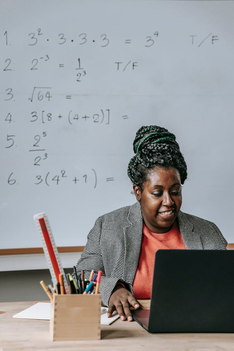 Black Woman With Laptop In Classroom