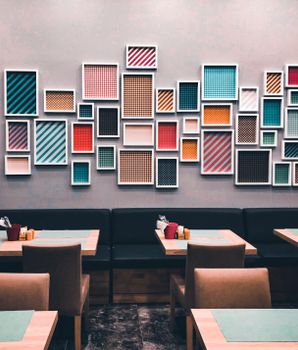 Stylish restaurant interior featuring colorful geometric art and contemporary decor.
