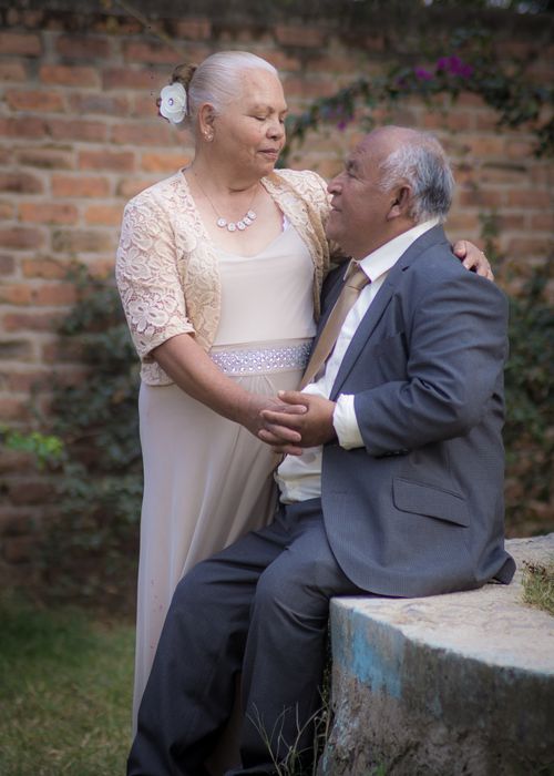 Free Elderly couple dressed in elegant attire, sharing a romantic moment outdoors. Stock Photo