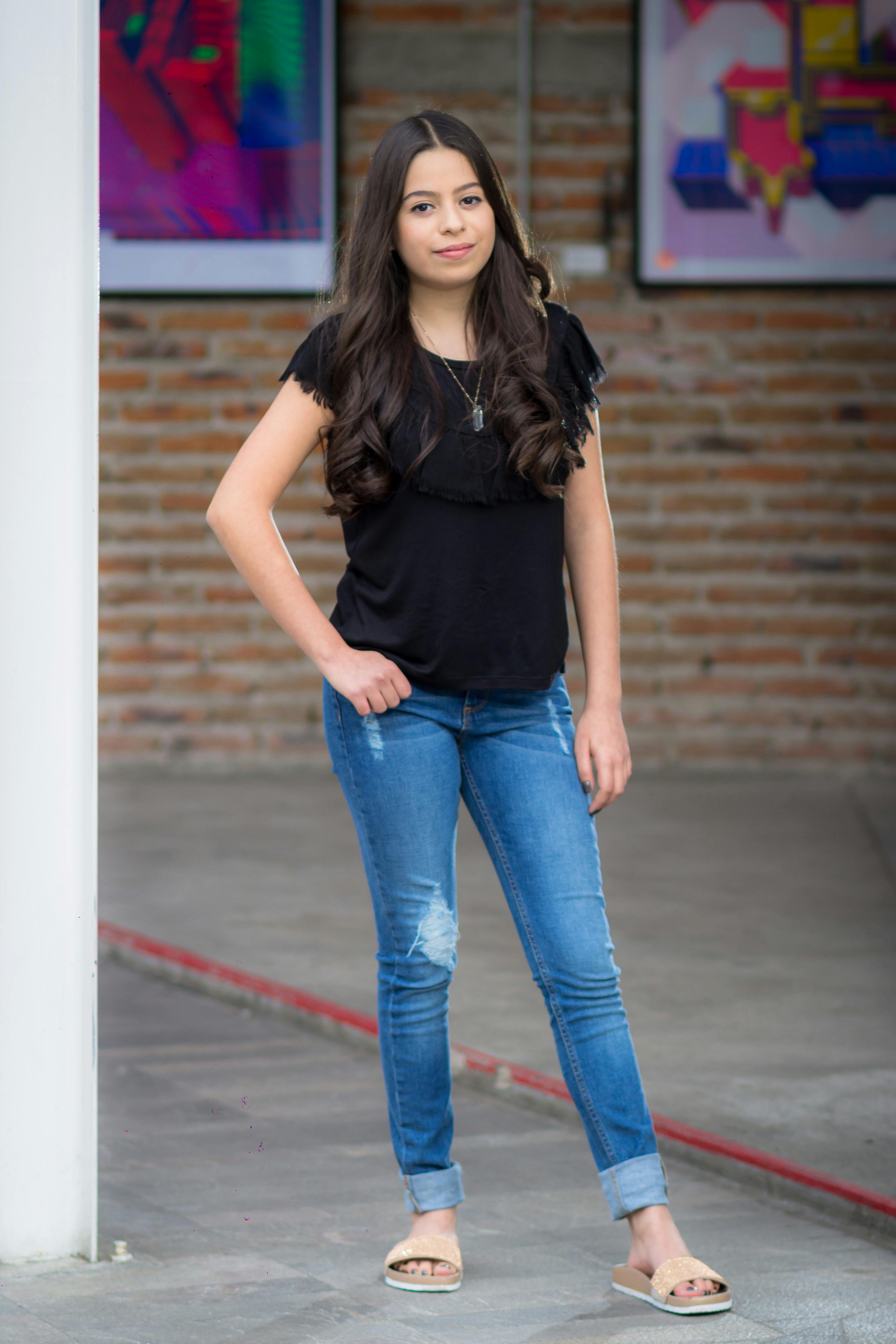 Woman Wearing Black T-shirt And Blue Denim Shorts Picture. Image: 113036035