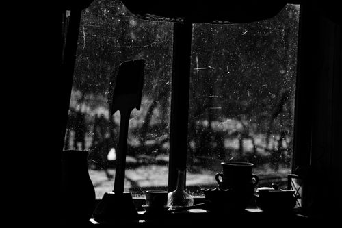 Free Black and white of jugs with cup and pan against window in aged building in countryside Stock Photo