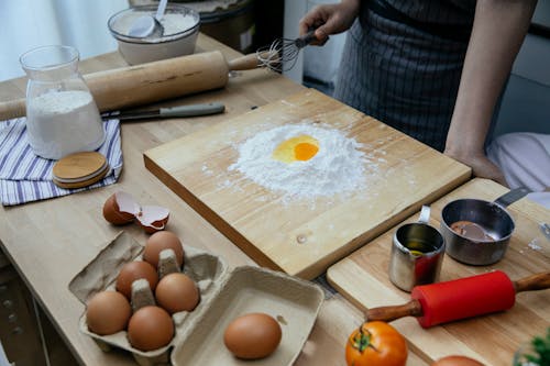 Free Crop woman cooking dough with flour and eggs Stock Photo