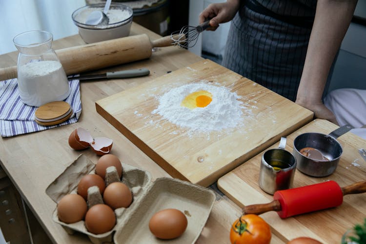 Crop Woman Cooking Dough With Flour And Eggs