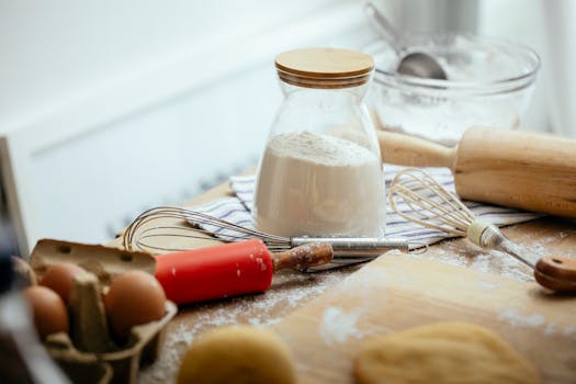 A cozy kitchen setting showing baking ingredients like flour, eggs, and a rolling pin.