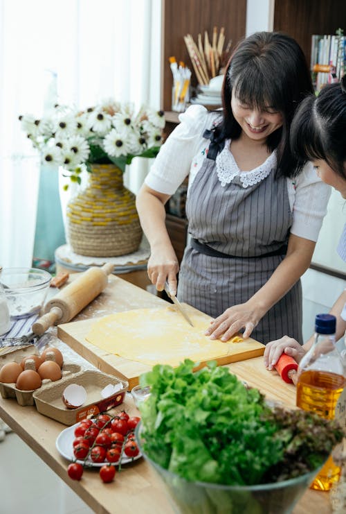 Free Woman making homemade noodles in kitchen Stock Photo