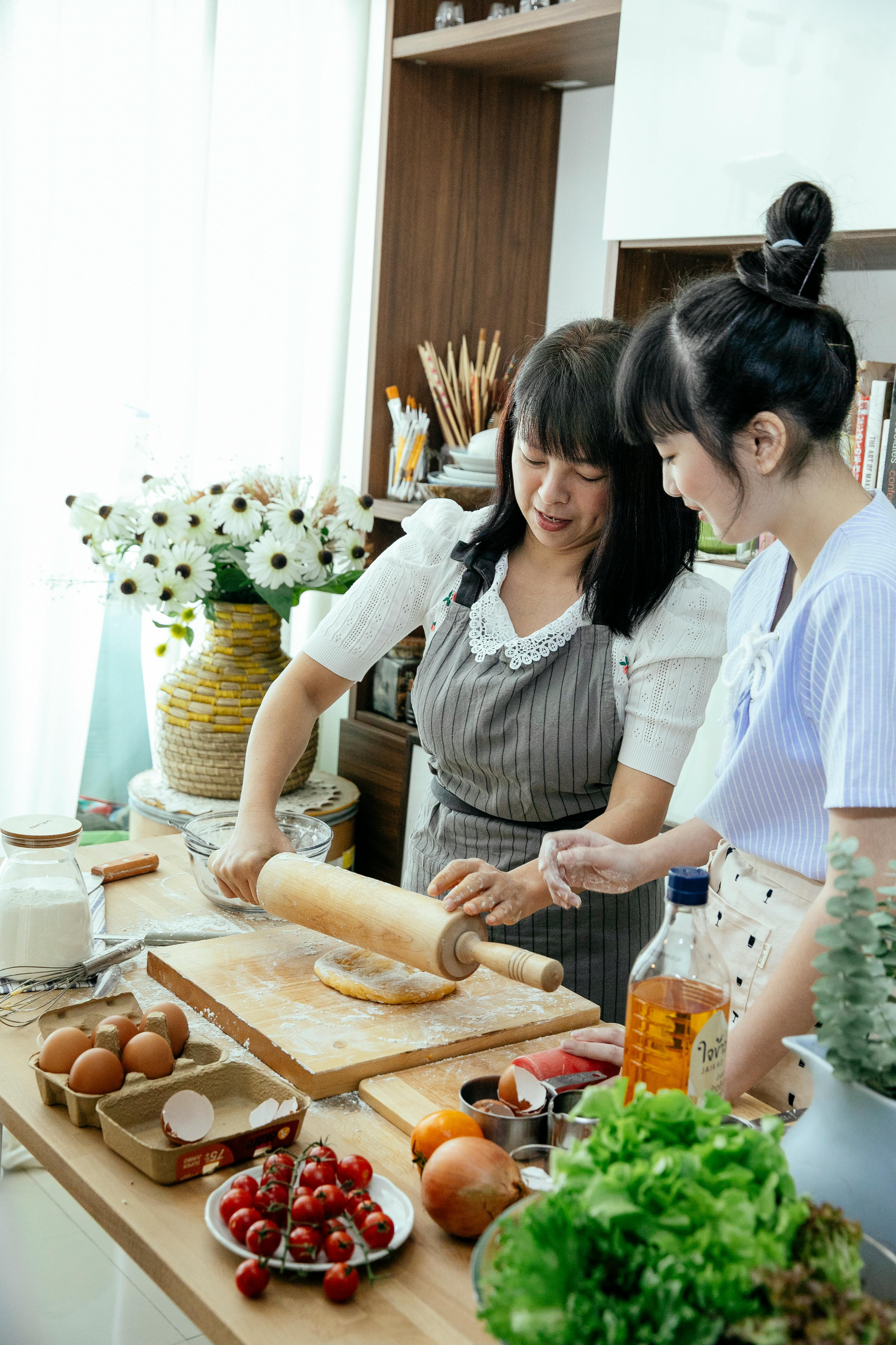 asian women making dough in kitchen