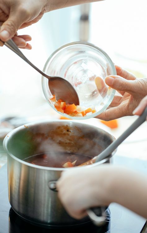Crop person adding tomatoes into pan · Free Stock Photo