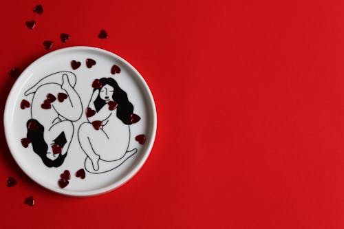 White Ceramic Plate on Red Background