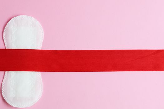 Conceptual image of a menstrual pad on a pink background symbolizing feminine hygiene.
