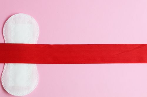Free Conceptual image of a menstrual pad on a pink background symbolizing feminine hygiene. Stock Photo