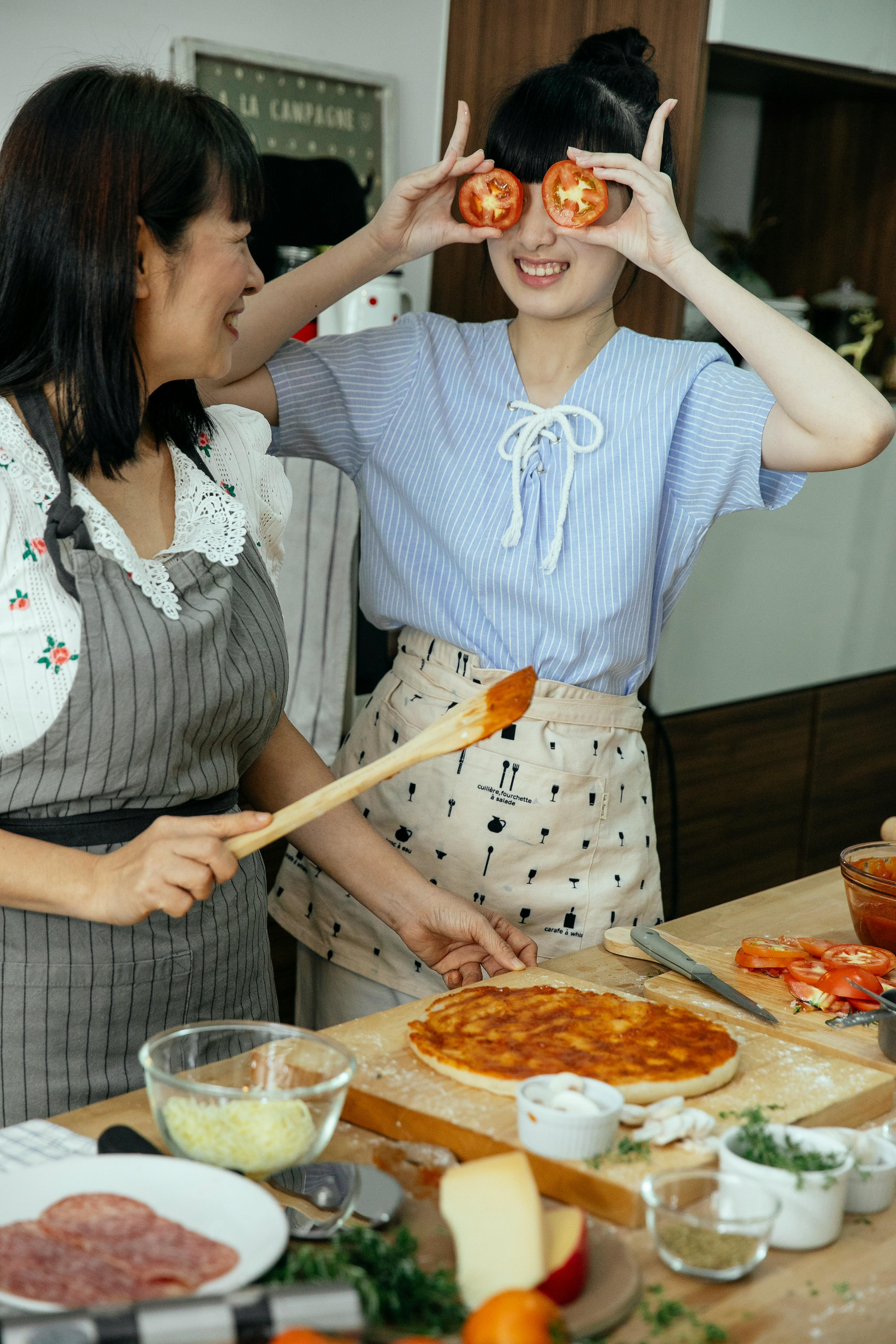 cheerful women having fun in kitchen