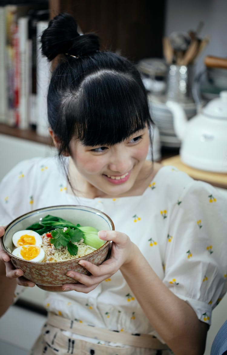 Cheerful Asian Woman With Bowl Of Fresh Ramen Soup