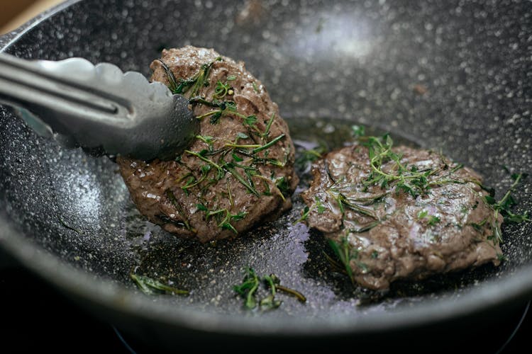 Frying Patties In Black Pan