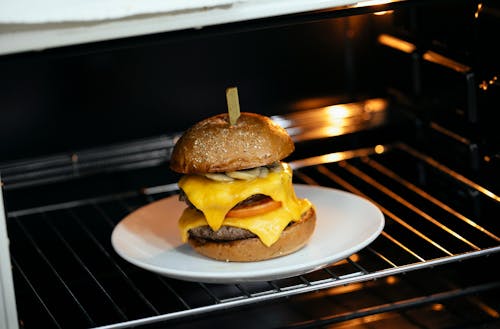 Free Appetizing burger in hot oven Stock Photo