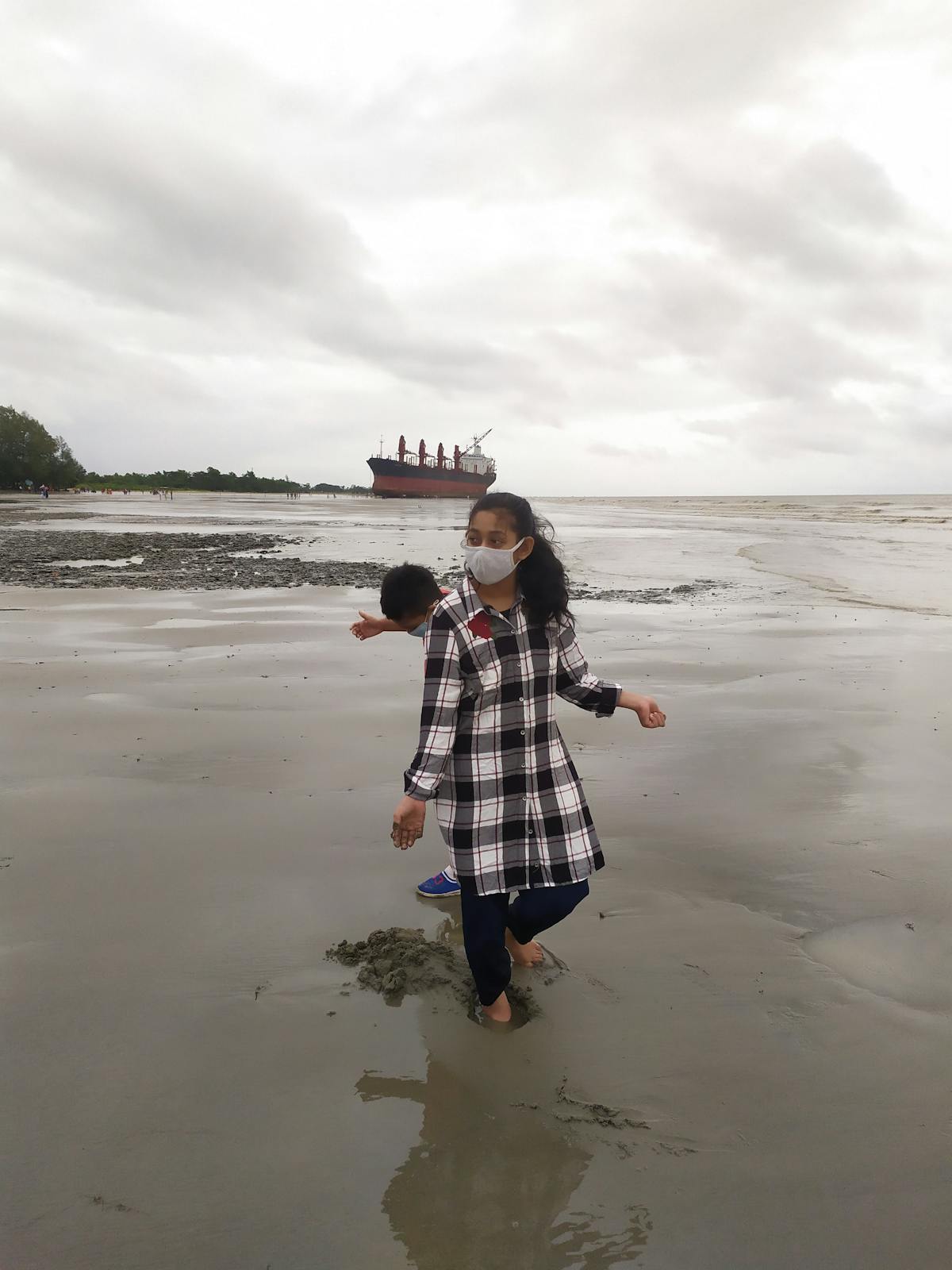 User with headphones speaking to a laptop screen