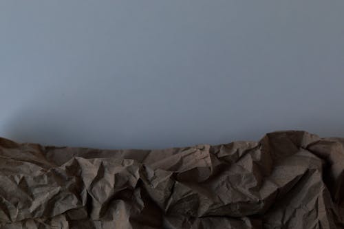 Brown Crumpled Paper on Plain Background