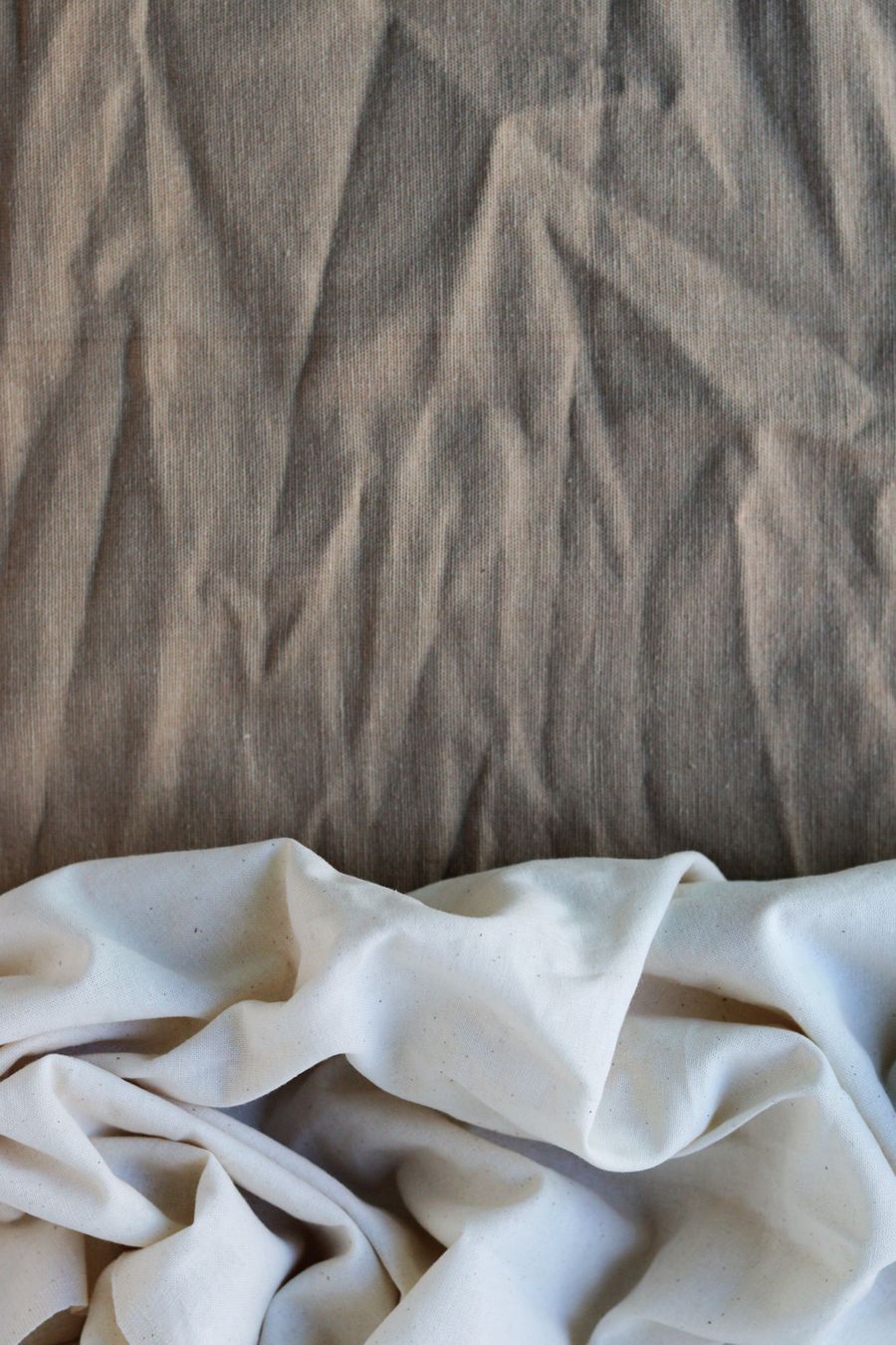 Folds of raw cloth resting under low light