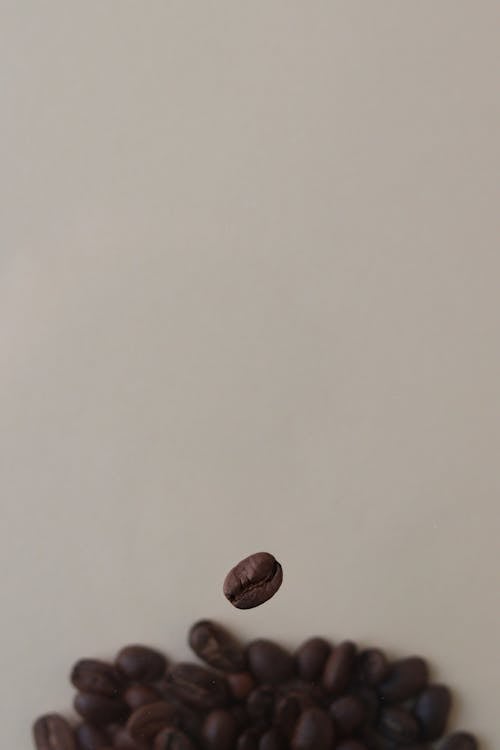 Free Selective Focus Photo of a Floating Roasted Coffee Bean Stock Photo