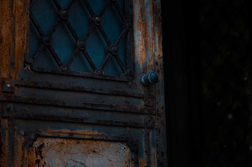 Free Low angle of opened shabby metal door of derelict damaged worn out house Stock Photo
