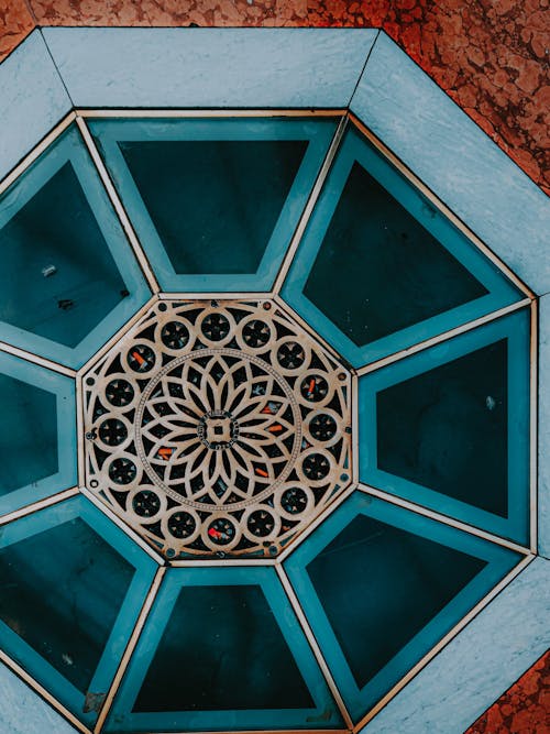 Top view ornamental geometric marble floor with blue glass and floral metal elements