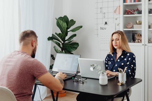 Free Man and Woman using Laptop Together Stock Photo