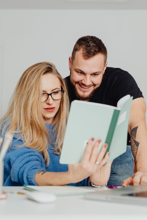 Free A young couple enjoying a book together in a cozy indoor setting. Stock Photo