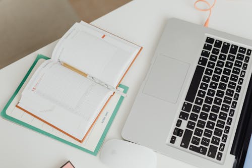 Notebook and a Laptop on a Desk