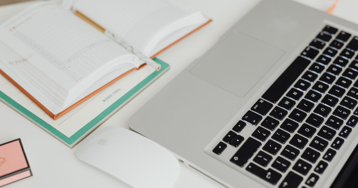 Laptop and calendar planner on a clean bright desk
