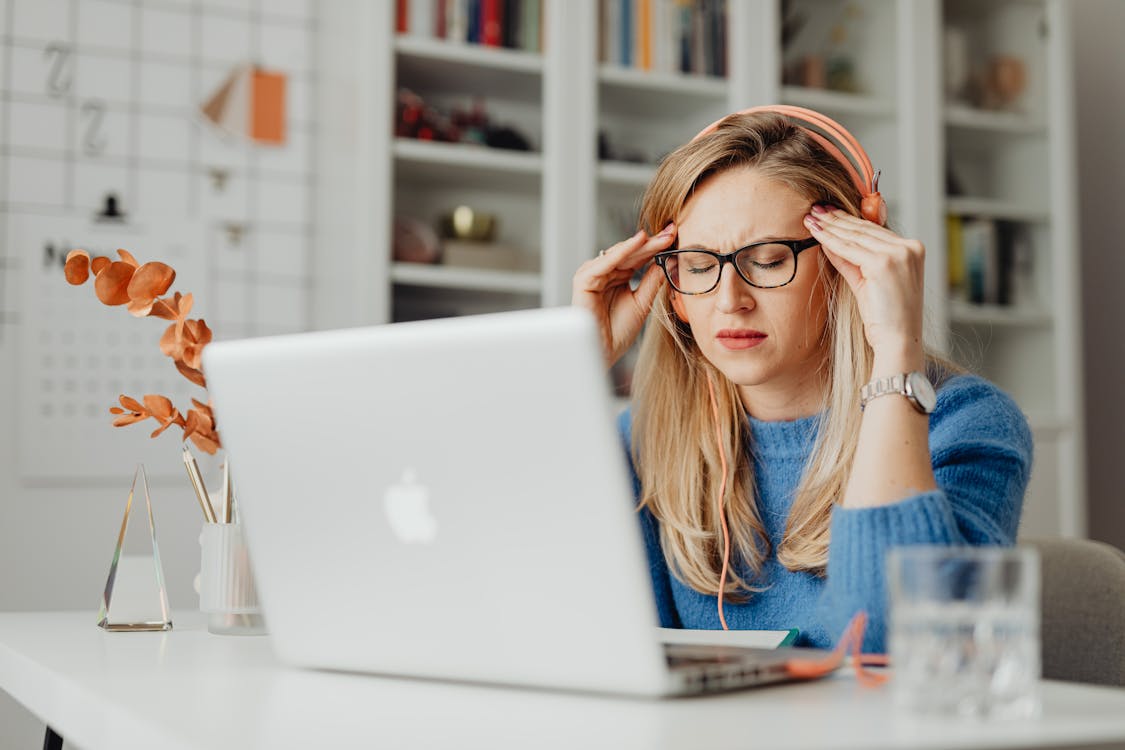 Free Woman in Blue Shirt Using Macbook Stock Photo