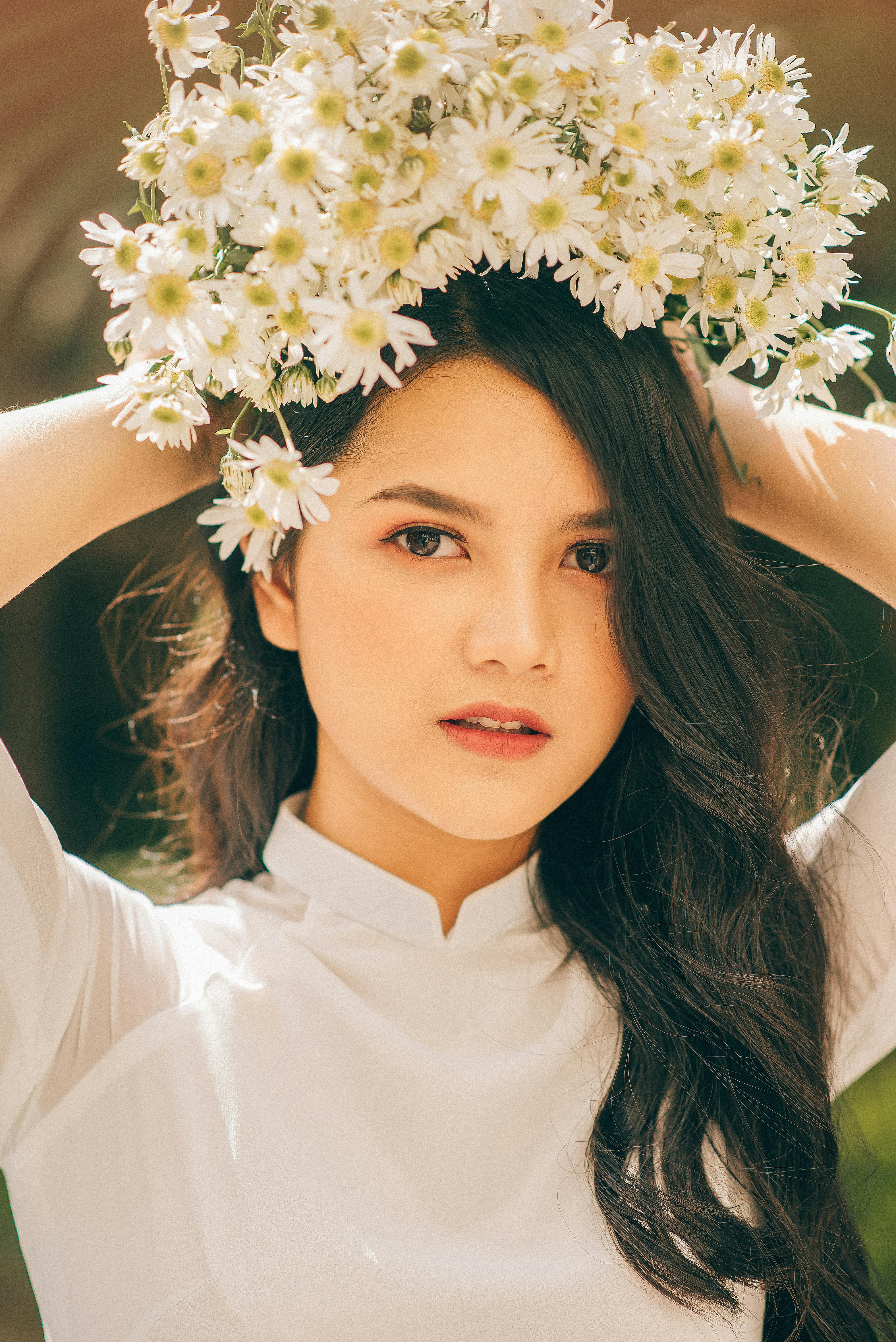 Portrait of an Asian woman in Vietnam wearing a flower crown, showcasing elegance and beauty.