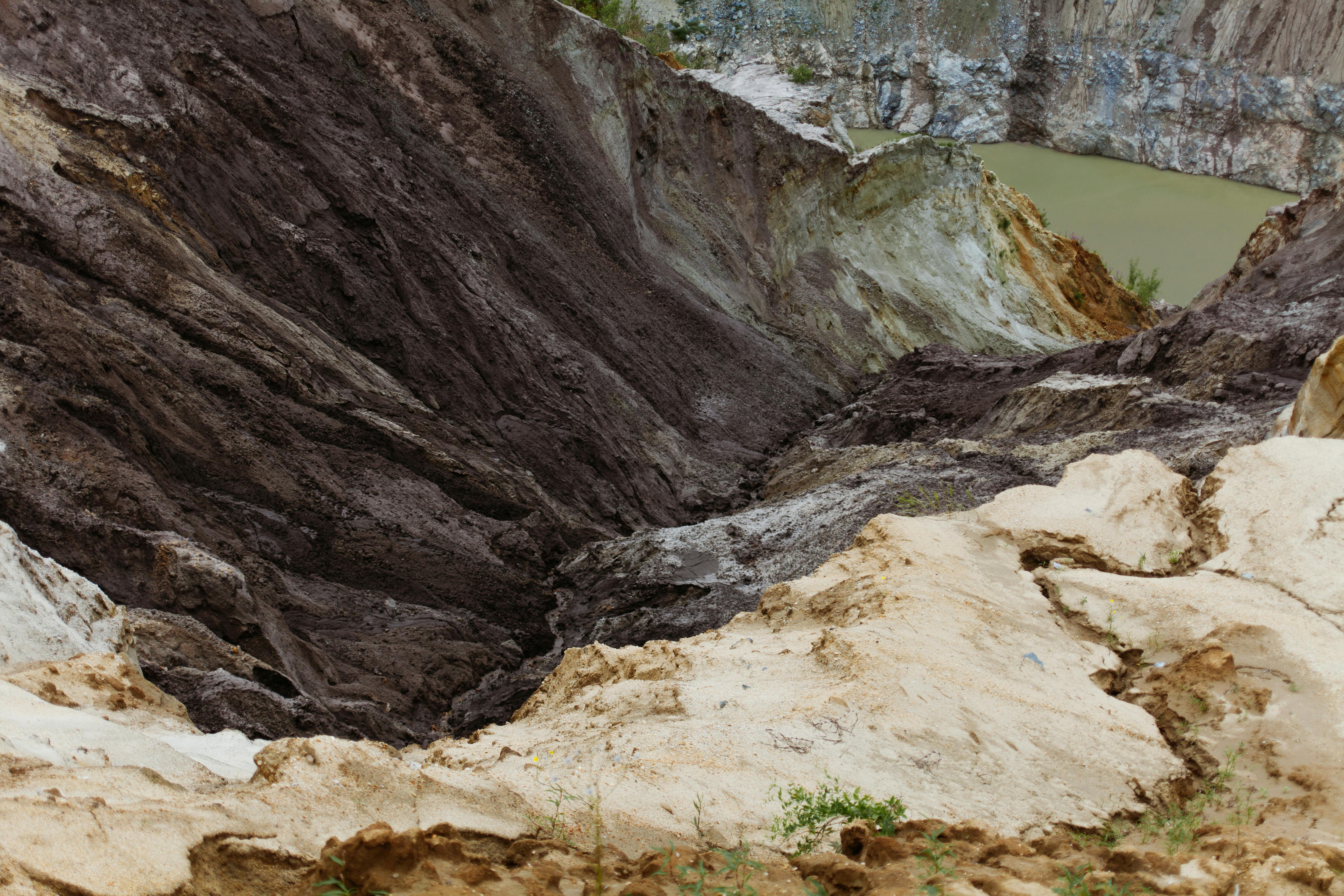 sandy formations near water and mountain