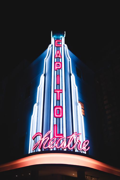 Free Facade of contemporary commerce building of nightclub or theater with shiny illumination at night Stock Photo