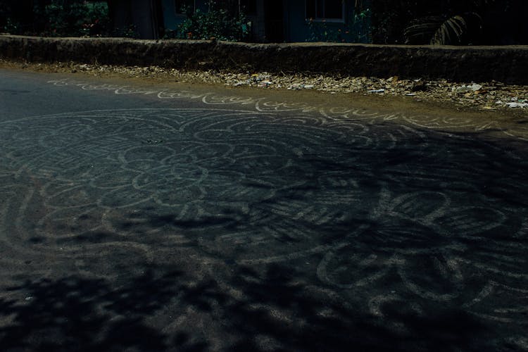 Pale Mandala Pattern On Asphalt Roadway In Countryside