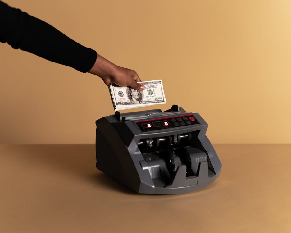 Free Person Using Money Counter Stock Photo