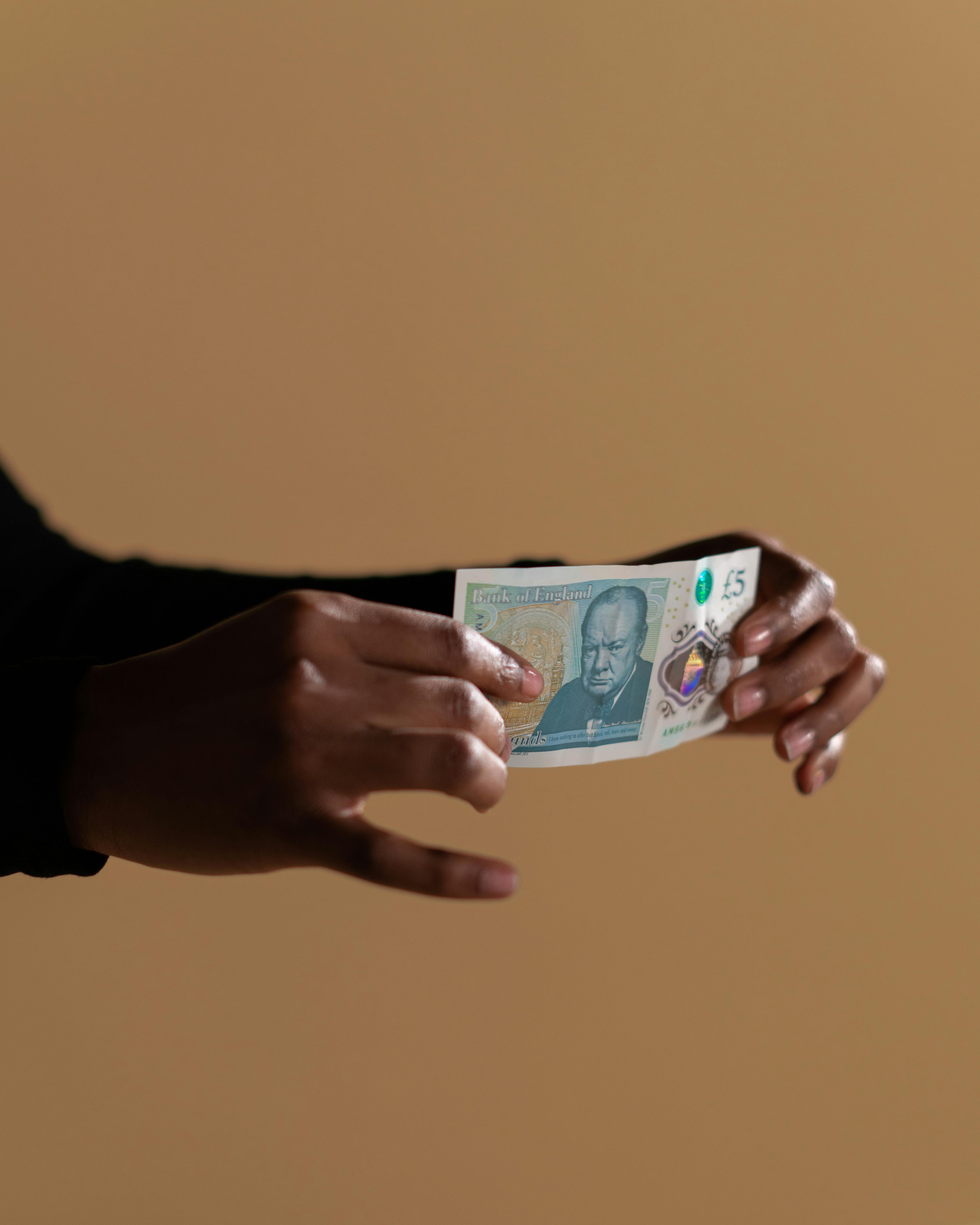 person holding a banknote