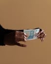 Person Holding a Banknote