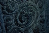 Old oriental tracery on stone pillar