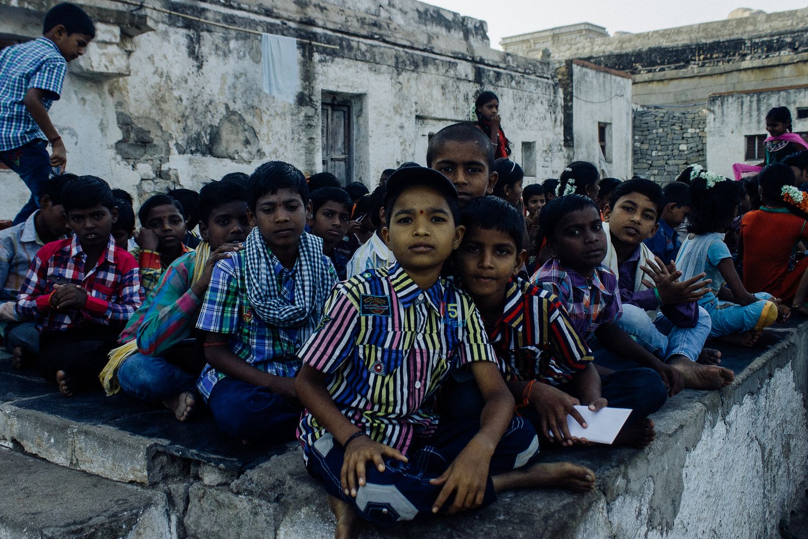 Group of young Indian children gathered outdoors in a rural village in India